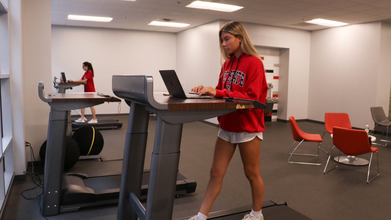 student walking on a treadmill while working