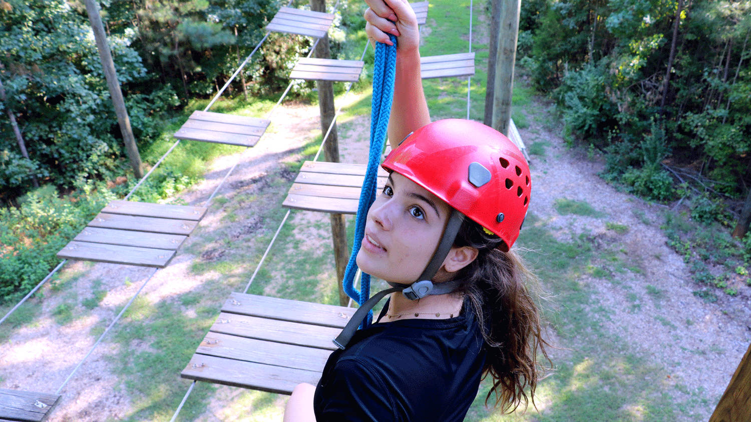 student climbing on the high ropes course