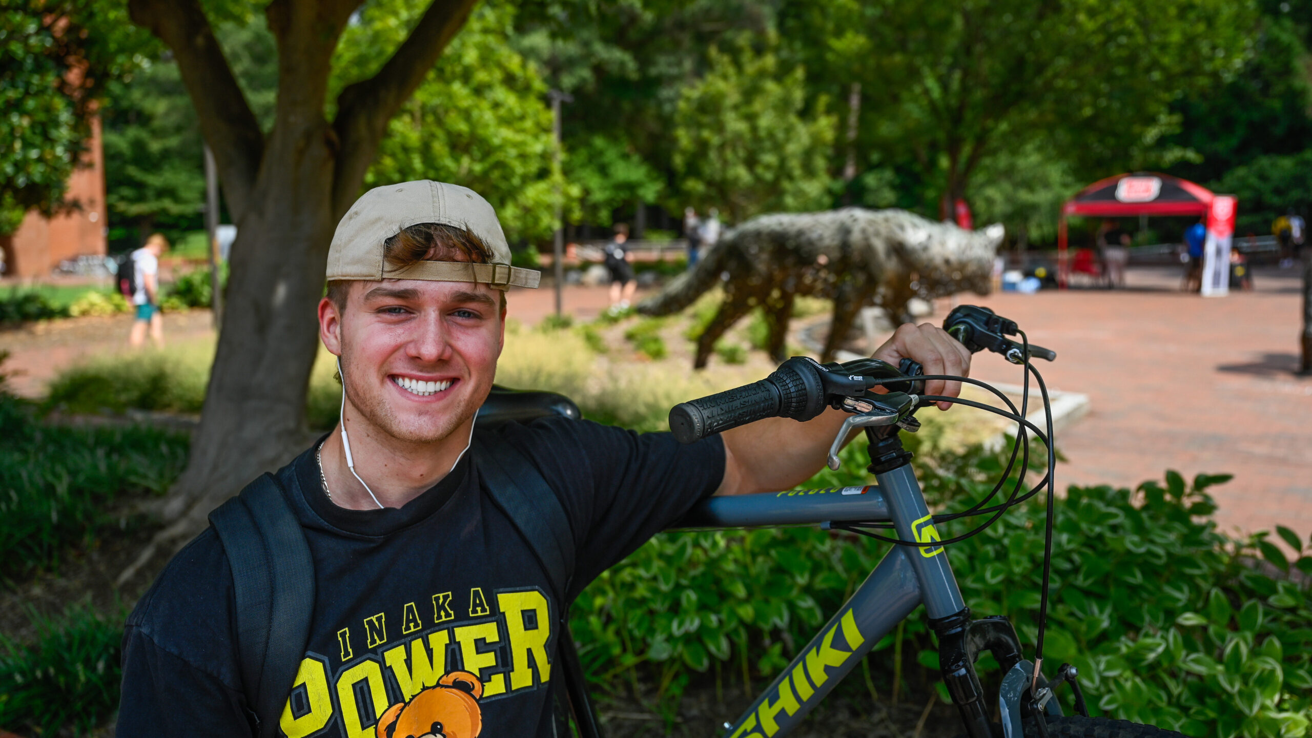 Michael McDermott sitting with his bike in a courtyard