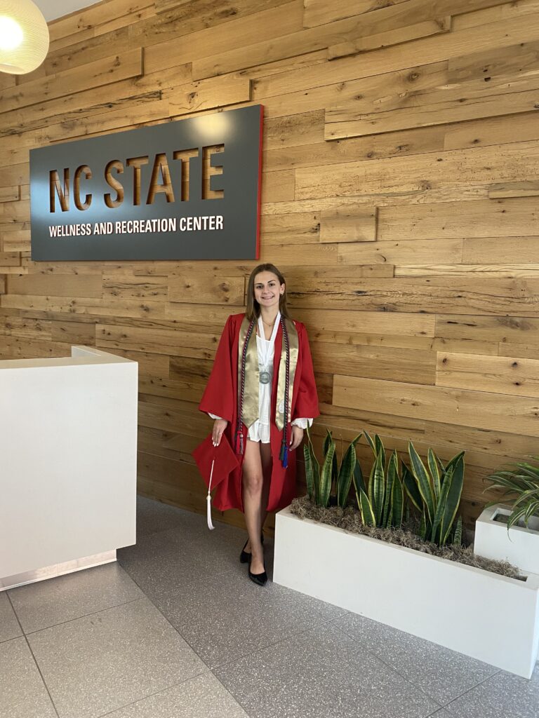Lily Palmer wearing Graduation Robes at the Wellrec Check-in desk