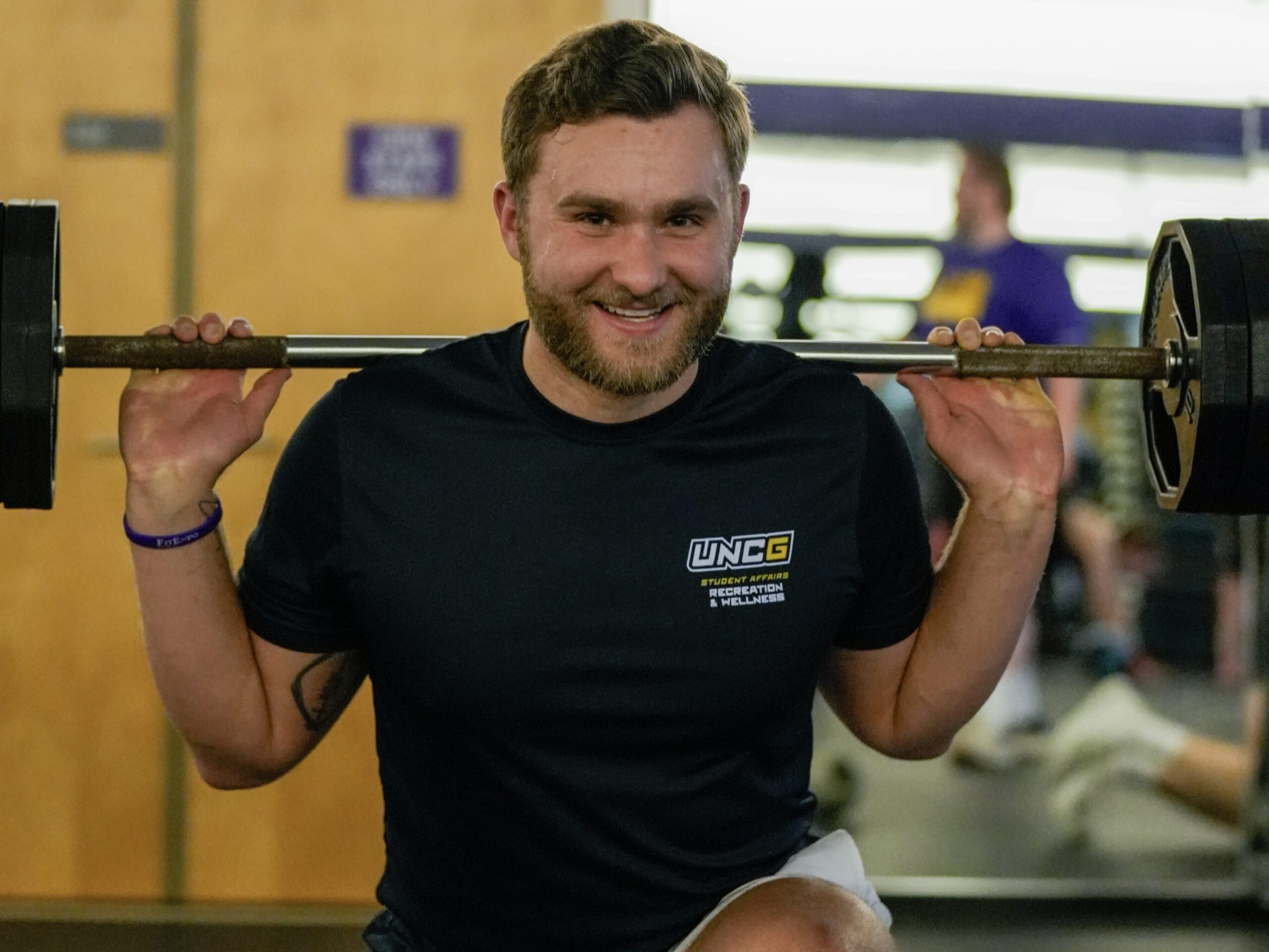 Jordan Kelber doing a lunge lift in the gym