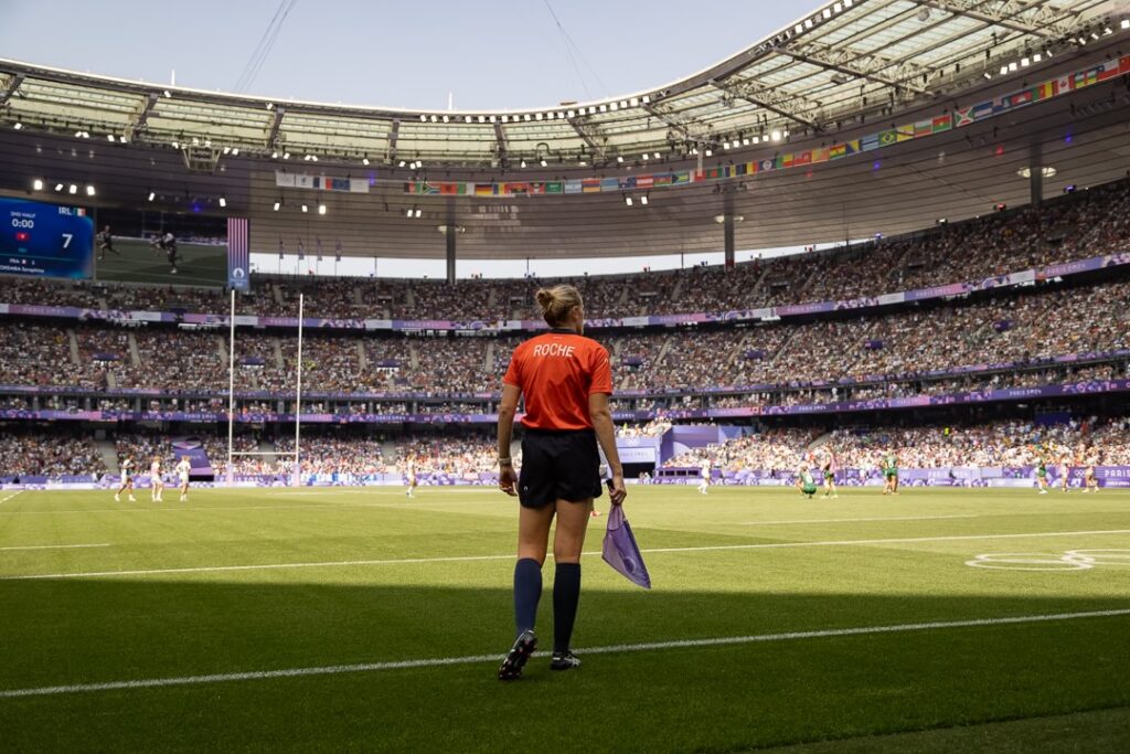 Kat Roche walking across the Olympic Rugby Stadium
